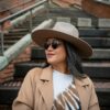 a woman wearing a brown hat and sunglasses