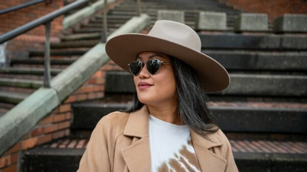 a woman wearing a brown hat and sunglasses